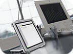 Photo of the Tablet PC in it's docking station on a desk.